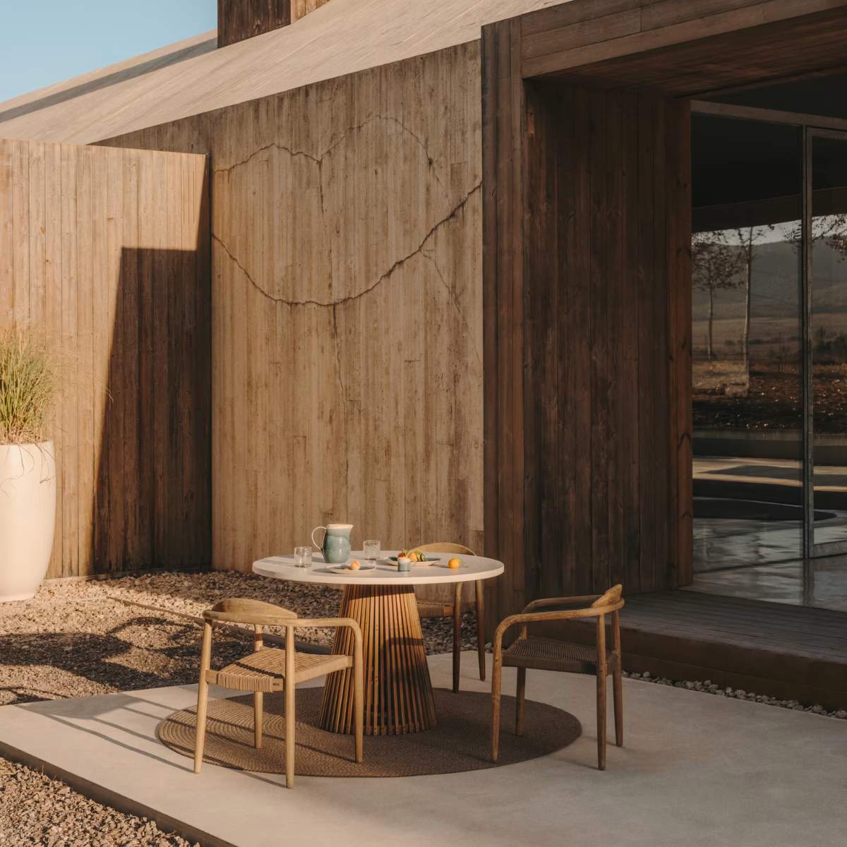 Kave Home Alcaufar round outdoor table made of solid teak wood and white cement Ø 90 cm