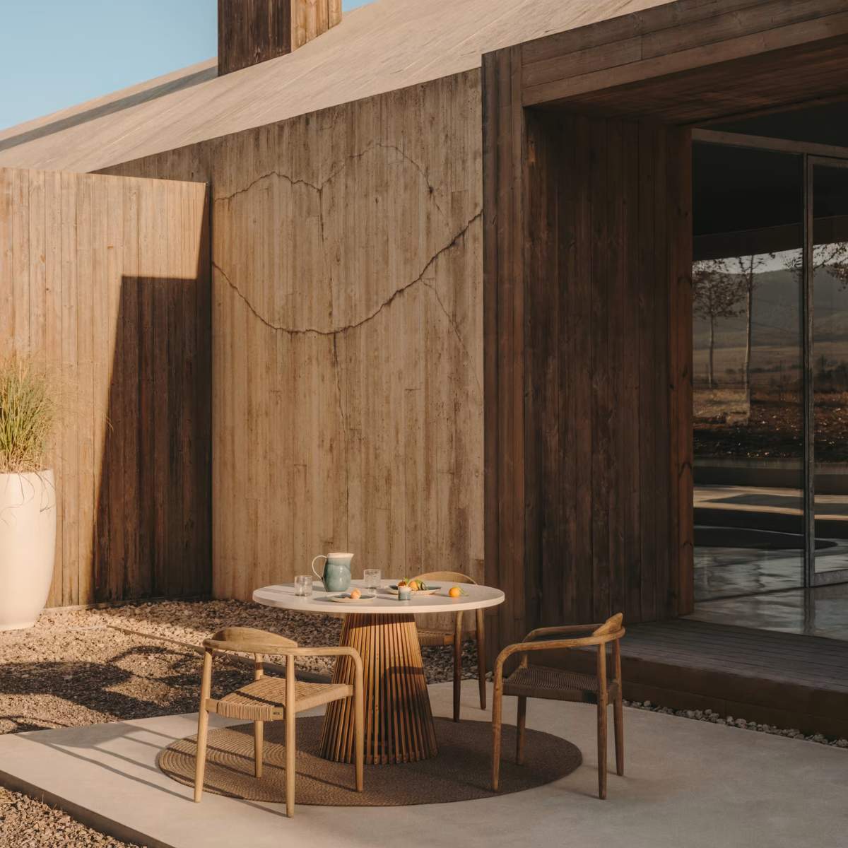Kave Home Alcaufar round outdoor table made of solid teak wood and grey cement Ø 90 cm