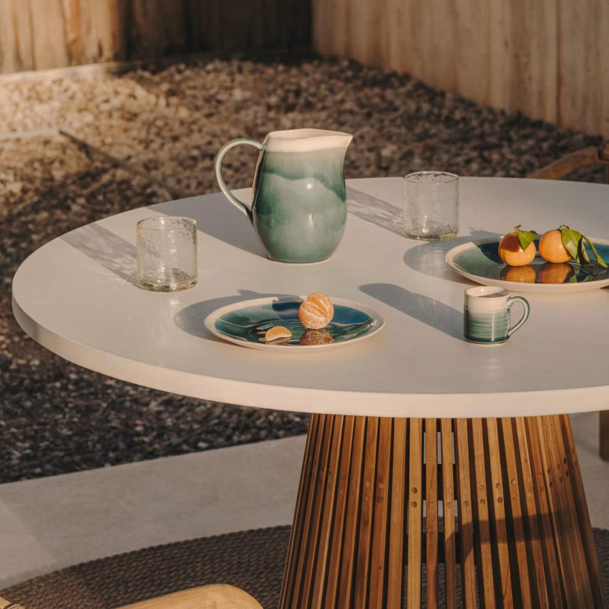 Kave Home Alcaufar round outdoor table made of solid teak wood and grey cement Ø 90 cm