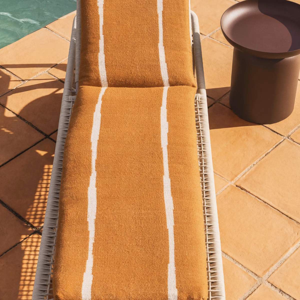 Kave Home Daila orange 100% PET sun lounger cushion with Ikat graphic 50 x 175cm