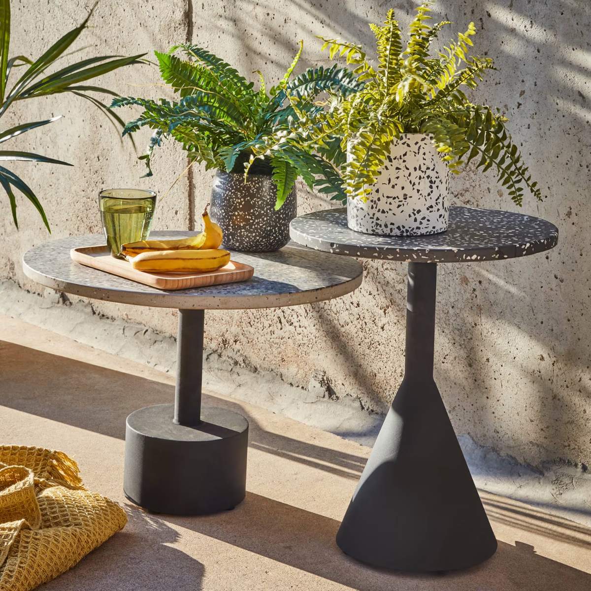 Kave Home Delano black terrazzo side table with steel legs in a black finish, Ø 40 cm