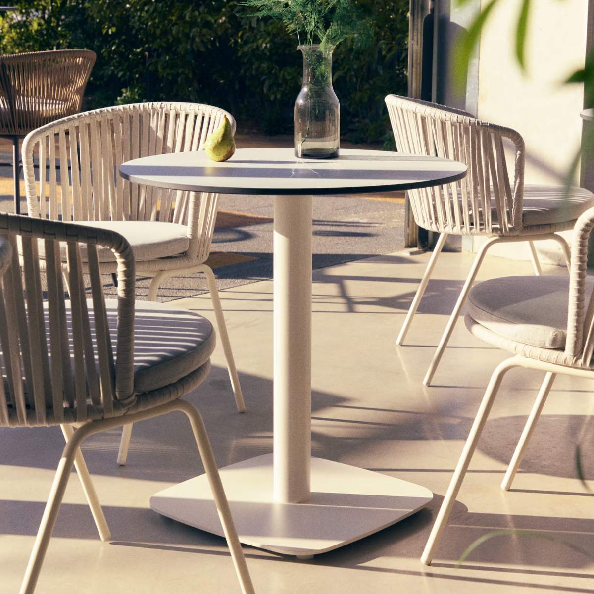 Kave Home Dina round outdoor table in white with metal legal in a painted white finish, Ø 68x70cm