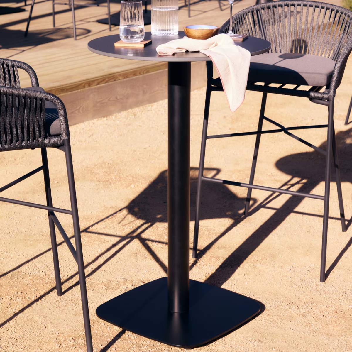 Kave Home Dina high round outdoor table in white with metal leg in a painted black finish, Ø60x96 cm