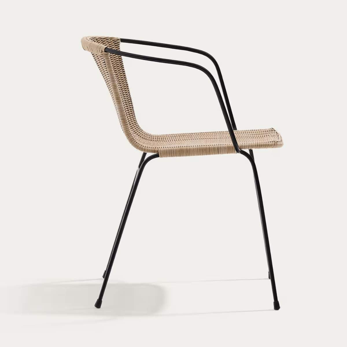 Kave Home Eltiera stackable chair in synthetic rattan with black steel frame and armrests