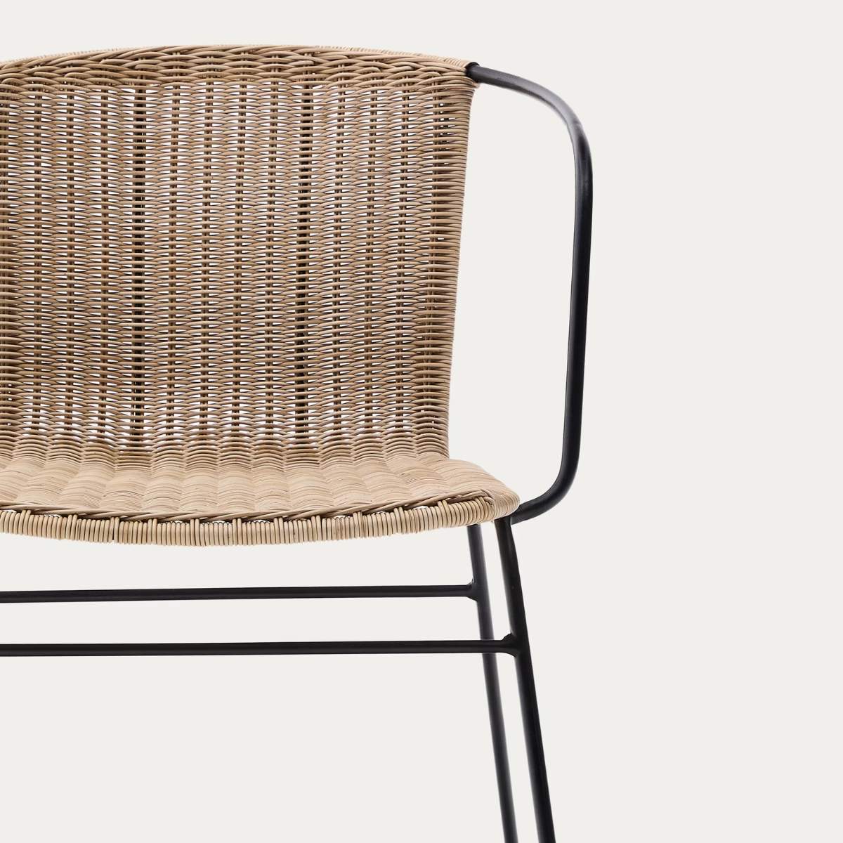Kave Home Eltiera stackable chair in synthetic rattan with black steel frame and armrests