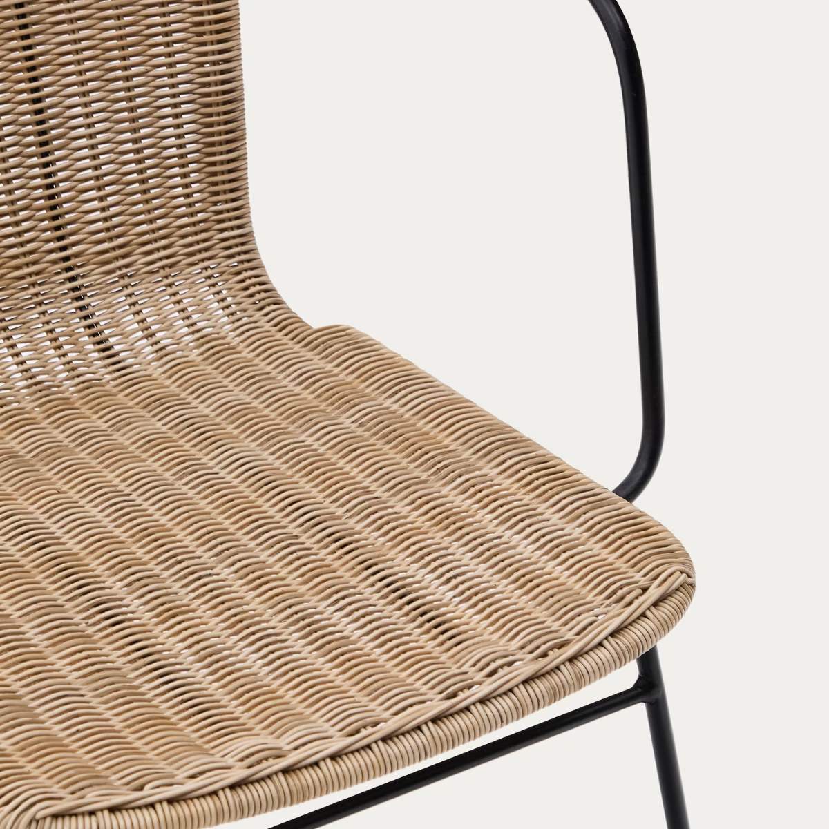 Kave Home Eltiera stackable chair in synthetic rattan with black steel frame and armrests