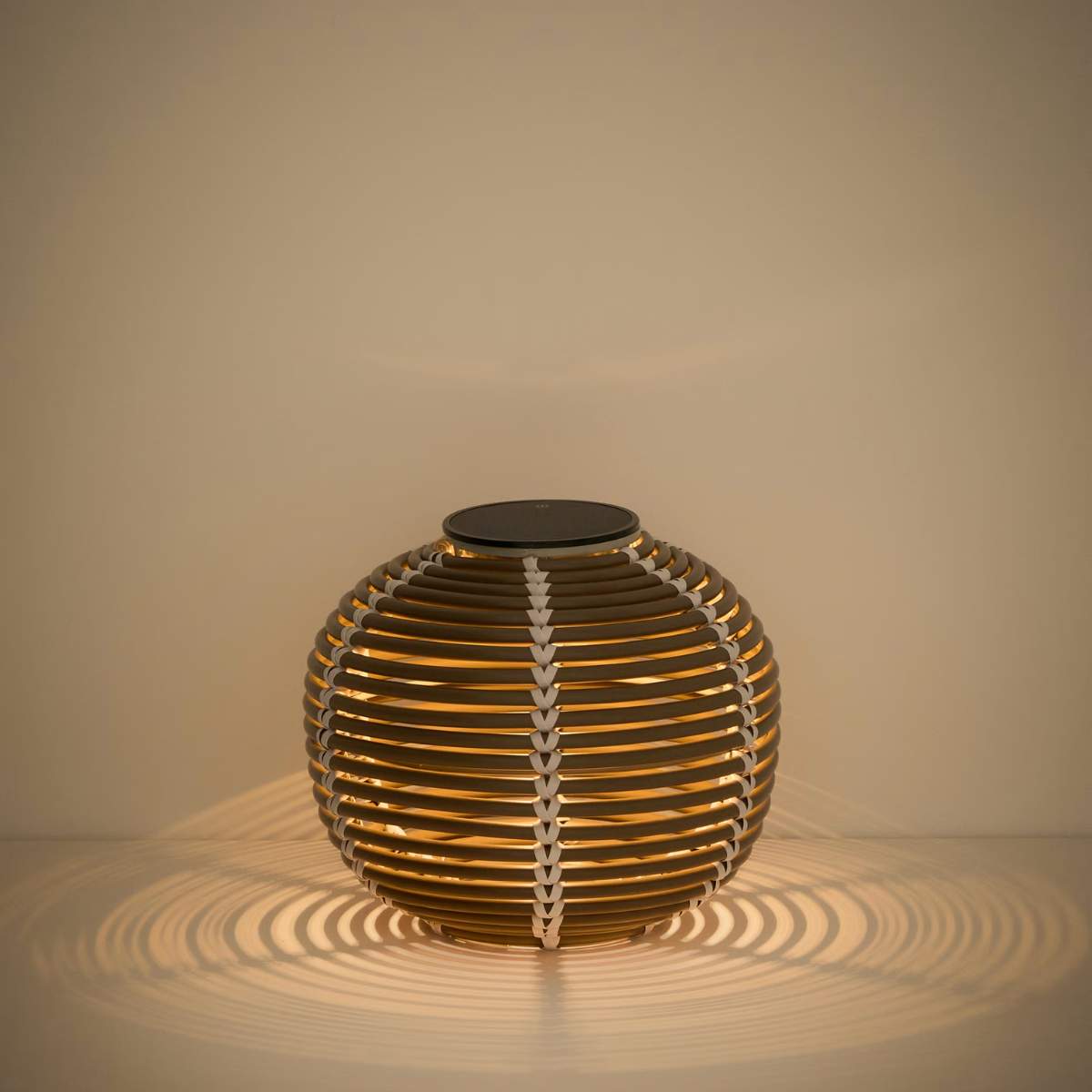 Kave Home Garoina outdoor solar LED table lamp in taupe synthetic rattan Ø25cm