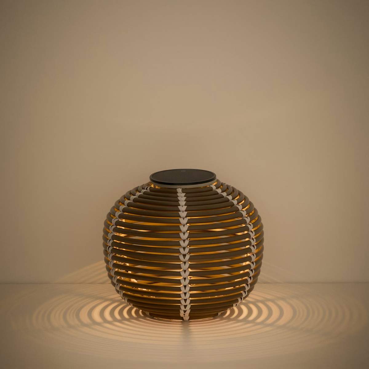 Kave Home Garoina outdoor solar LED table lamp in taupe synthetic rattan Ø25cm