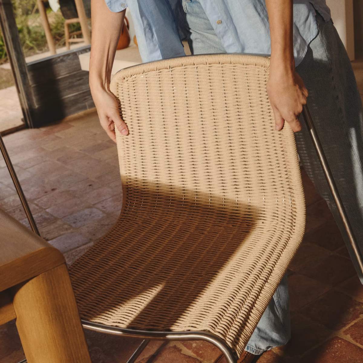 Kave Home Tavari stackable chair in beige synthetic rope cord and AISI 304 stainless steel with brushed finish