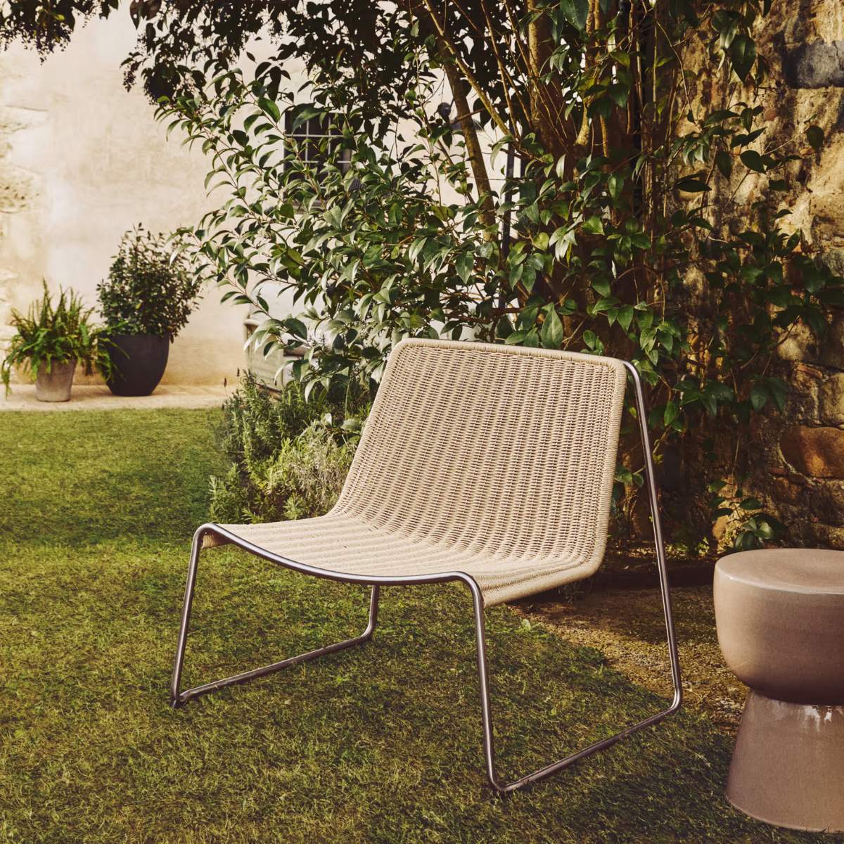 Kave Home Tavari stackable armchair in beige synthetic rope cord and AISI 304 stainless steel with brushed finish