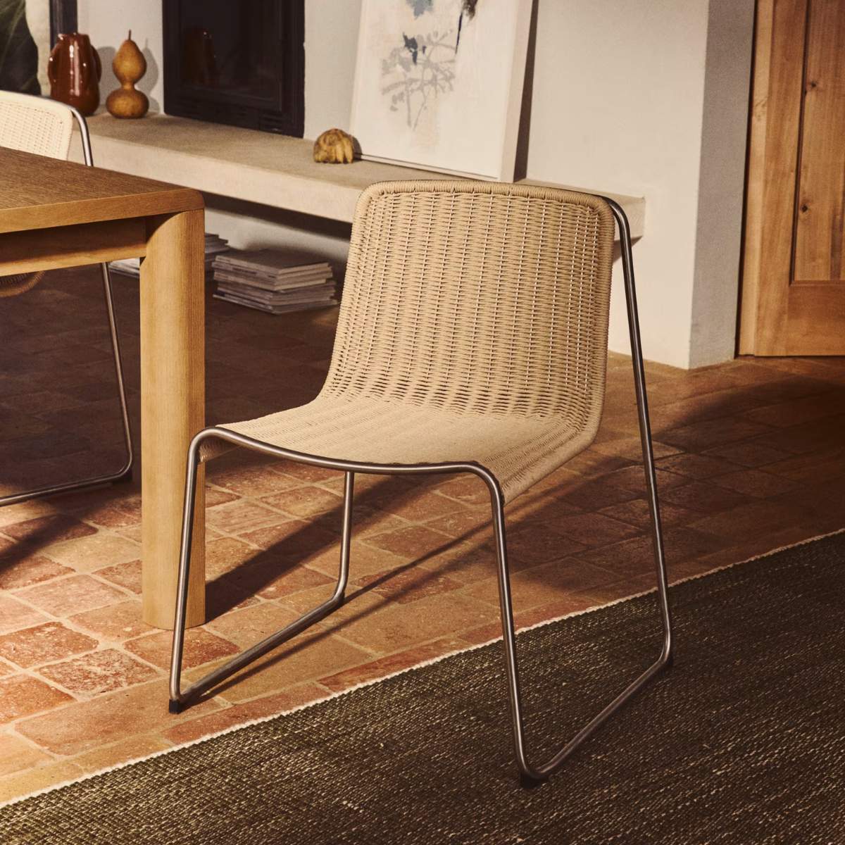 Kave Home Tavari stackable chair in beige synthetic rope cord and AISI 304 stainless steel with brushed finish