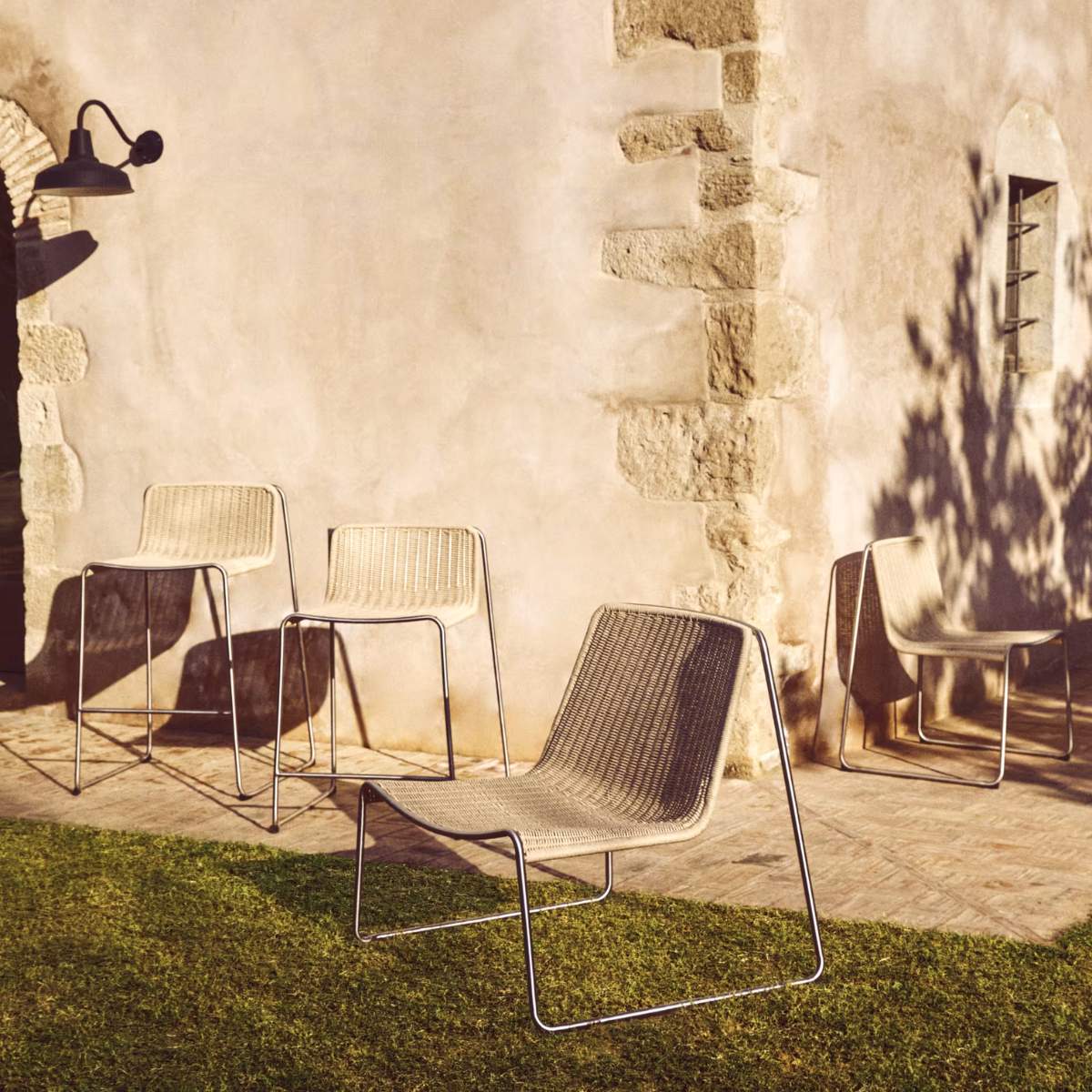Kave Home Tavari stackable armchair in beige synthetic rope cord and AISI 304 stainless steel with brushed finish