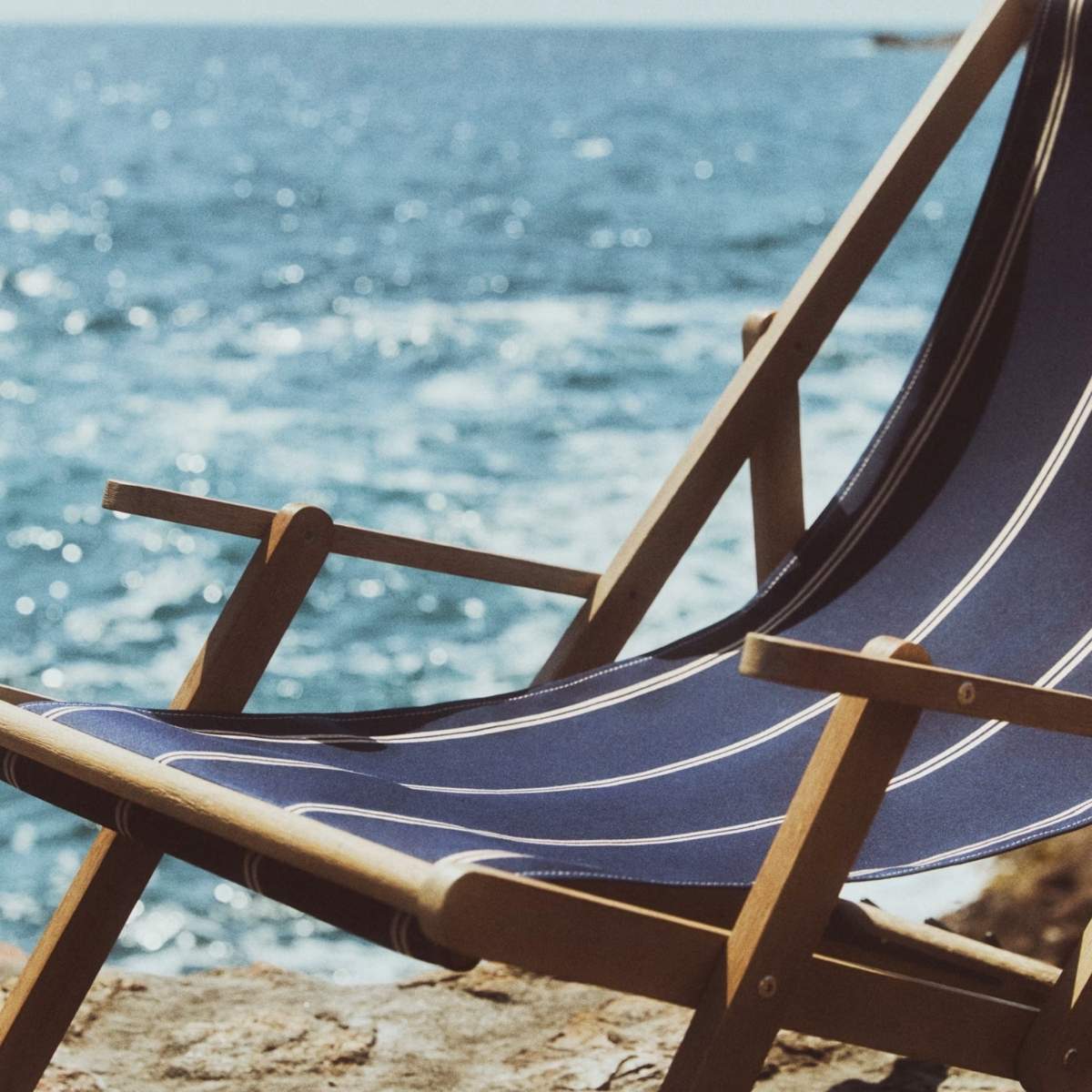 Kave Home Vilara brown and beige striped outdoor folding deck chair made of FSC 100% solid acacia wood